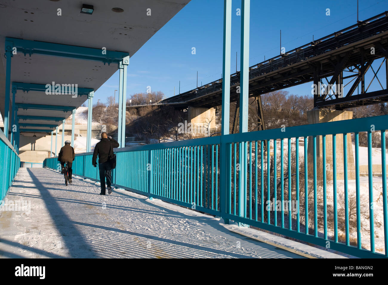 Edmonton, Alberta, Canada; People walking on a foot bridge Stock Photo