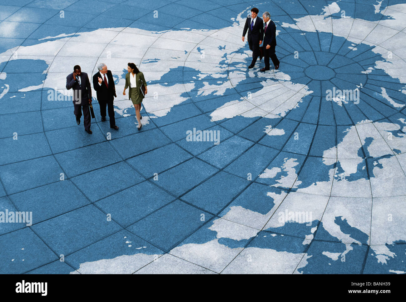 Businesspeople walking on map of globe Stock Photo