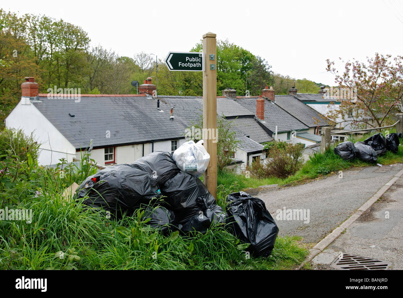 black plastic bin bags left outside cottages in cornwall,uk Stock Photo