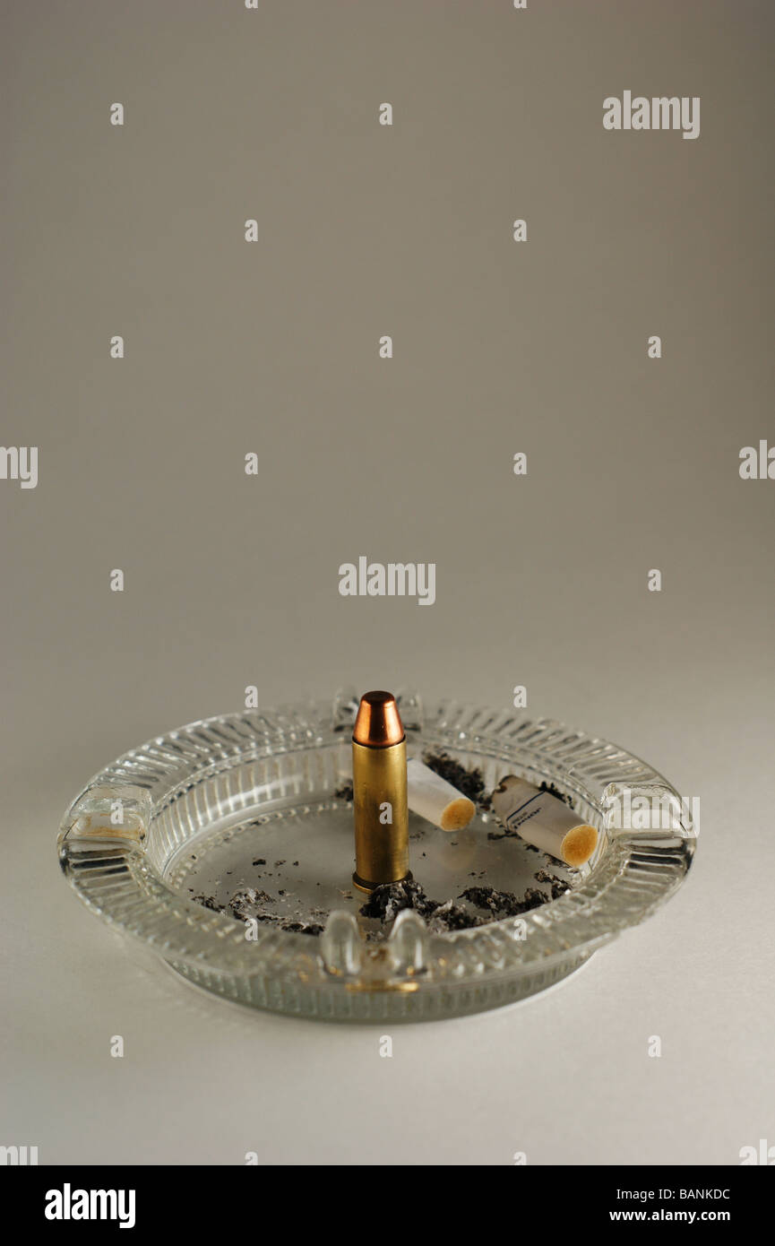 Bullet in an ashtray Stock Photo