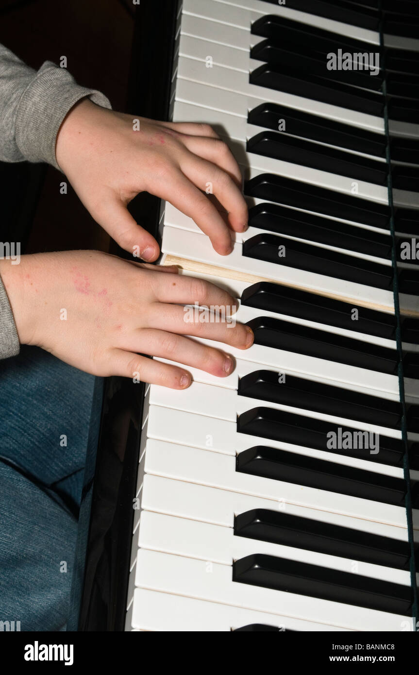 Small childs hands playing piano keys Stock Photo Alamy