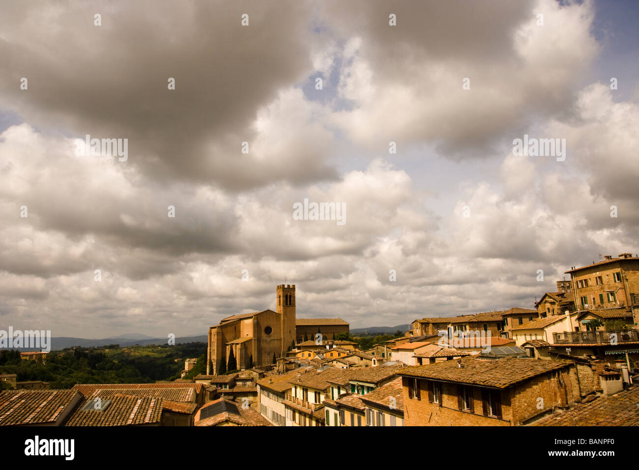 Wide-angle rooftop view of Ancient walled city of Siena Italy and San Domenico cathedral also known as Basilica Cateriniana Stock Photo