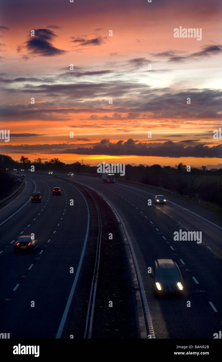Road traffic on the M5 motorway at sunset, near Dursley, Gloucestershire. Stock Photo
