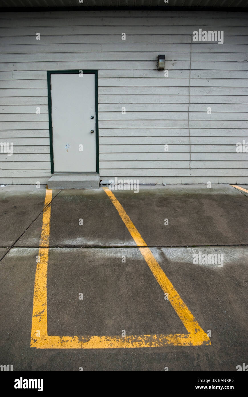 Yellow paint marks a noparking zone in front of a service entrance of