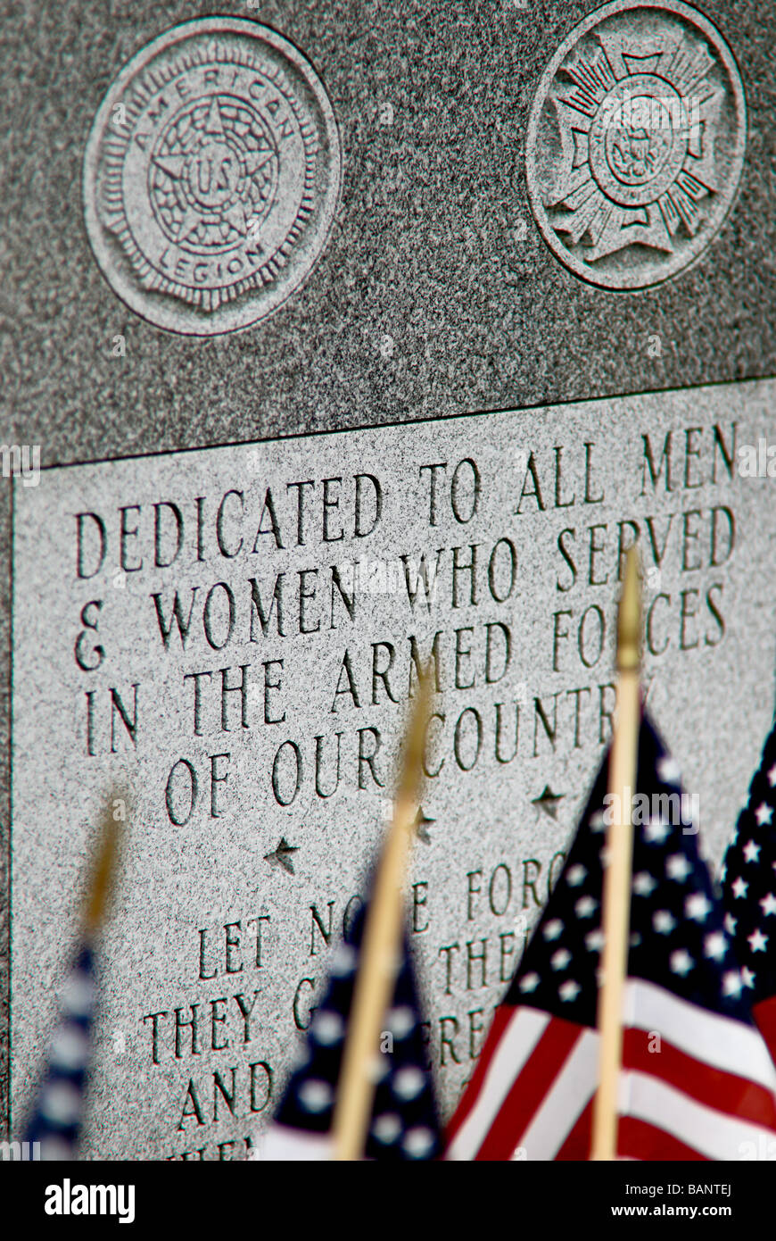 A memorial dedicated to men and women of the armed forces is surrounded by American flags. Stock Photo