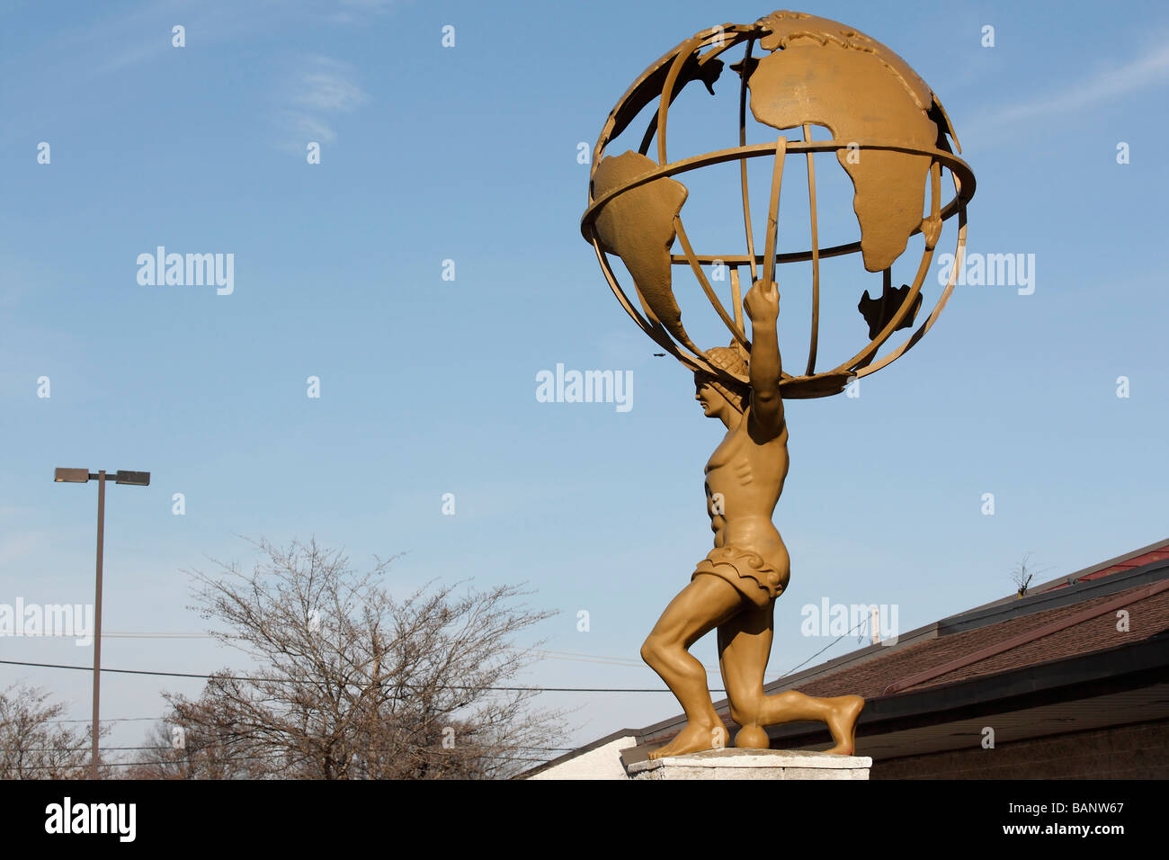 Atlas holding the globe.The statue of Globe Atlas athletick Sculpture of Atlas carrying a globe in side metal figure of man close up of nobody hi-res Stock Photo