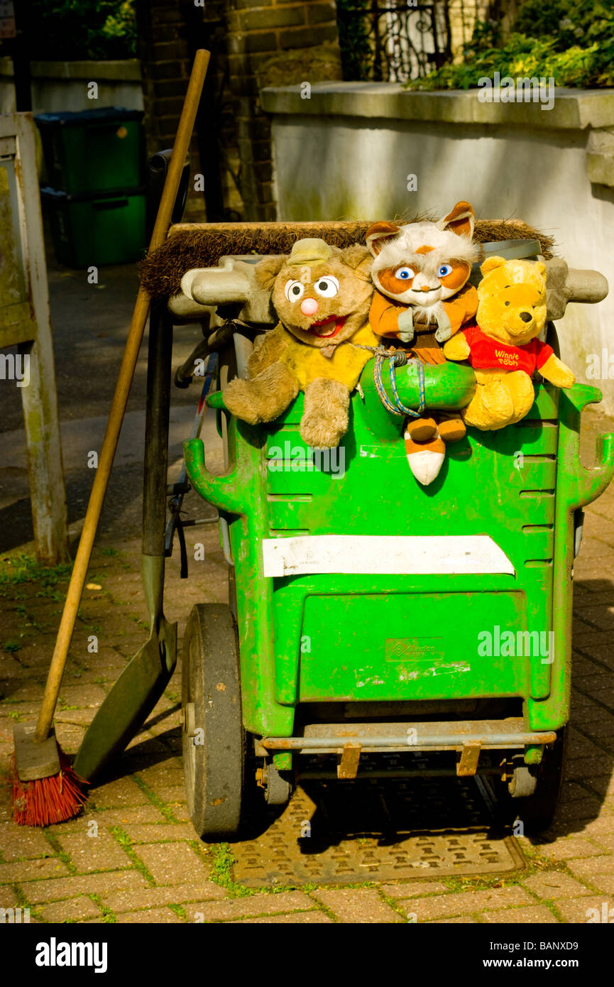 A street sweeper's dust cart, decorated with rescued, abandoned teddies. Seen in a  residential street in Highgate,North London Stock Photo