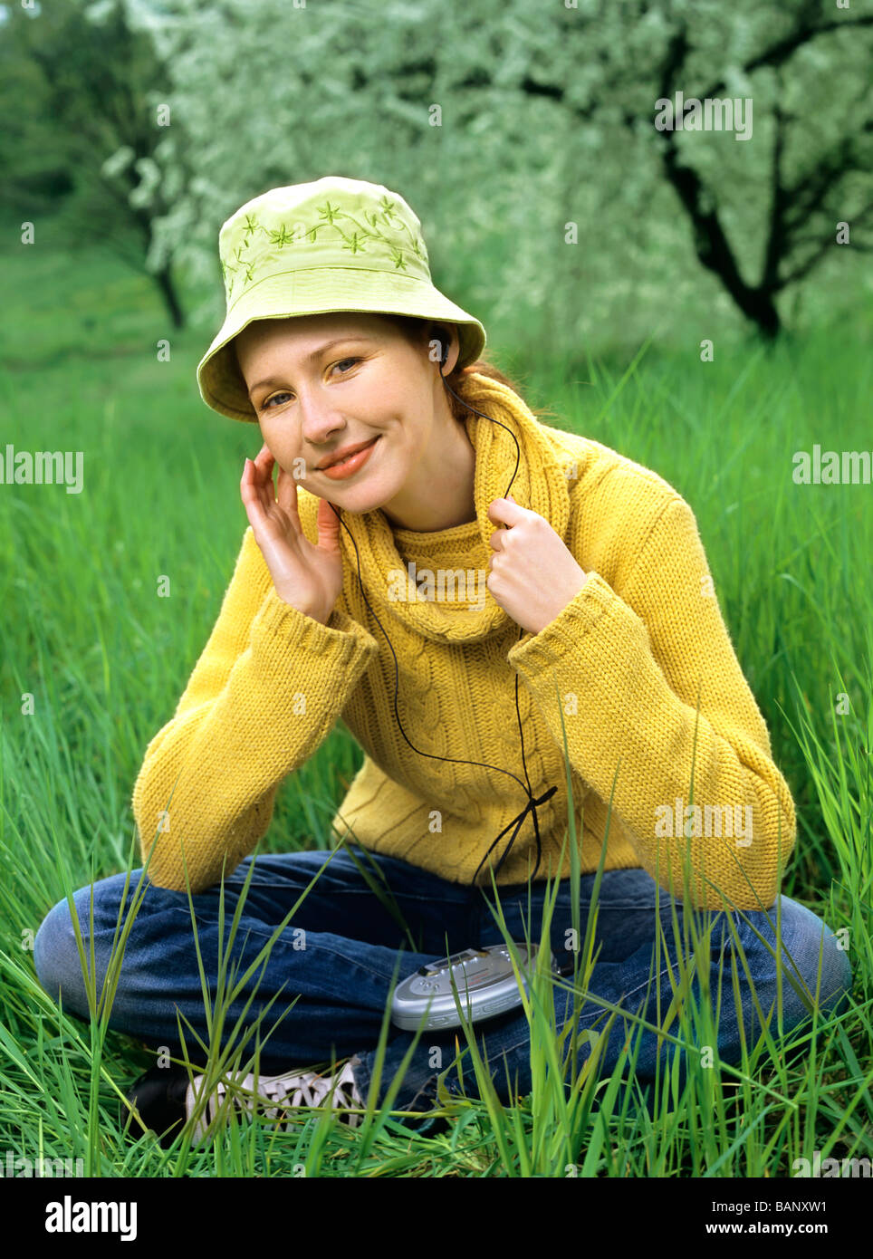 people, woman, 25-30, 30-35, red-haired, hat, listen, music, discman, headphones, smile, smiling, orchard, outdoor, summer, ver Stock Photo