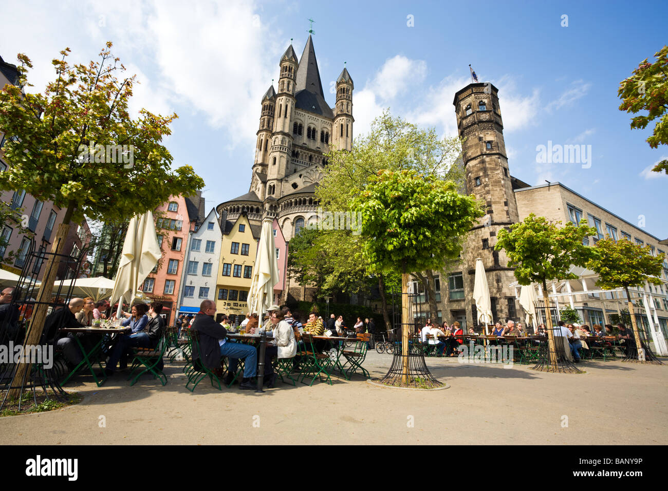 Biergarten at Cologne Old Town, church Saint Martin in background Stock Photo