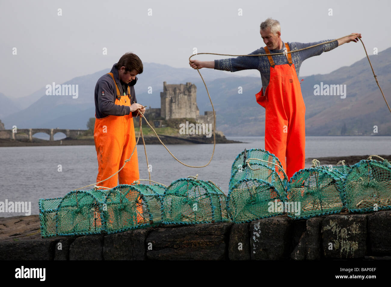 Two Scottish Creel or Lobster Prawn Fishermen with creels, at Loch