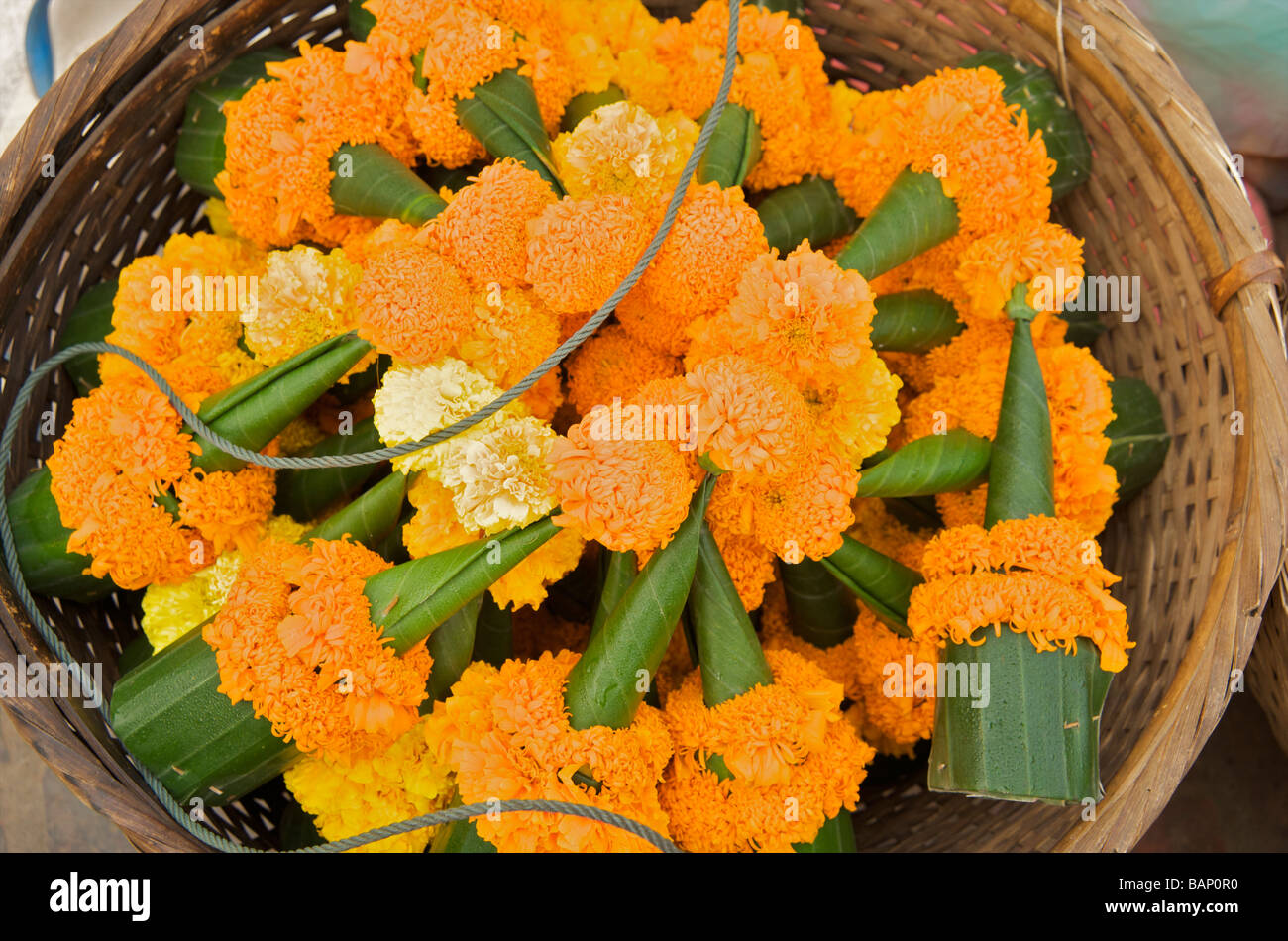 Banana leaf marigold flower sculptures temple offerings Luang Prabang