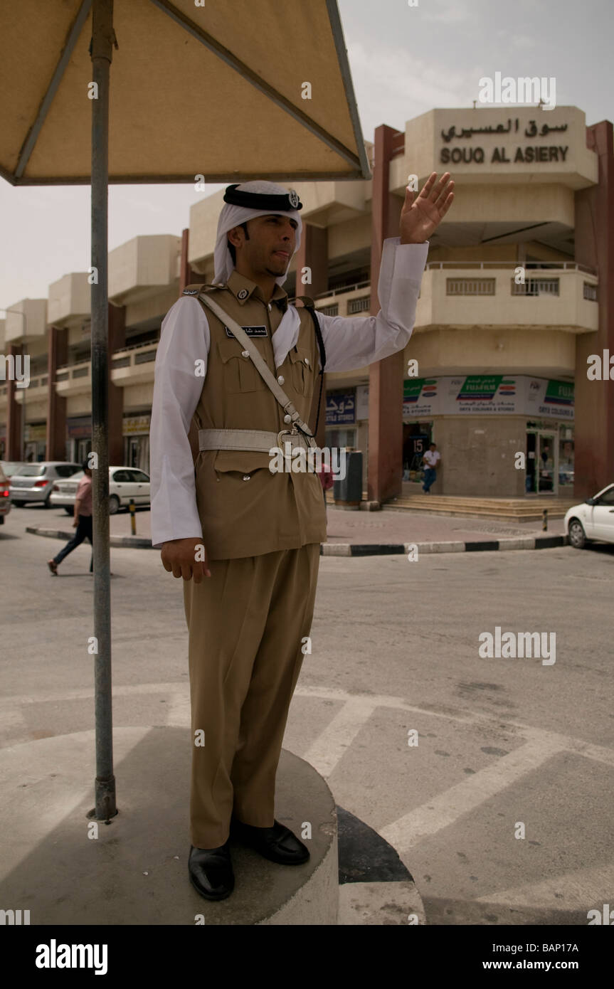 Traffic Policeman on Point duty on a traffic island in the old quarter of Doha, Qatar Stock Photo