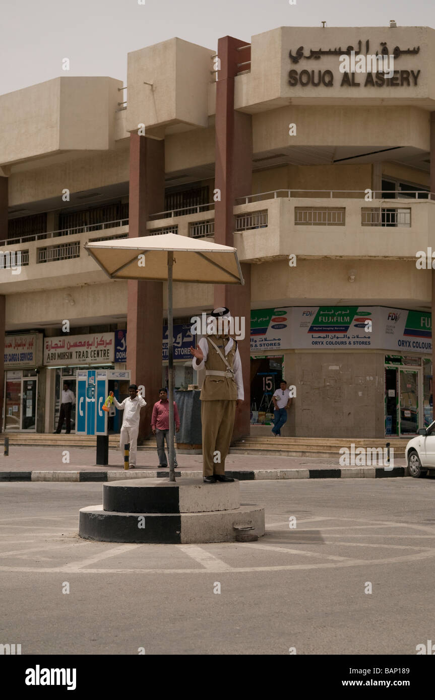 Traffic Policeman on Point duty on a traffic island in the old quarter of Doha, Qatar Stock Photo