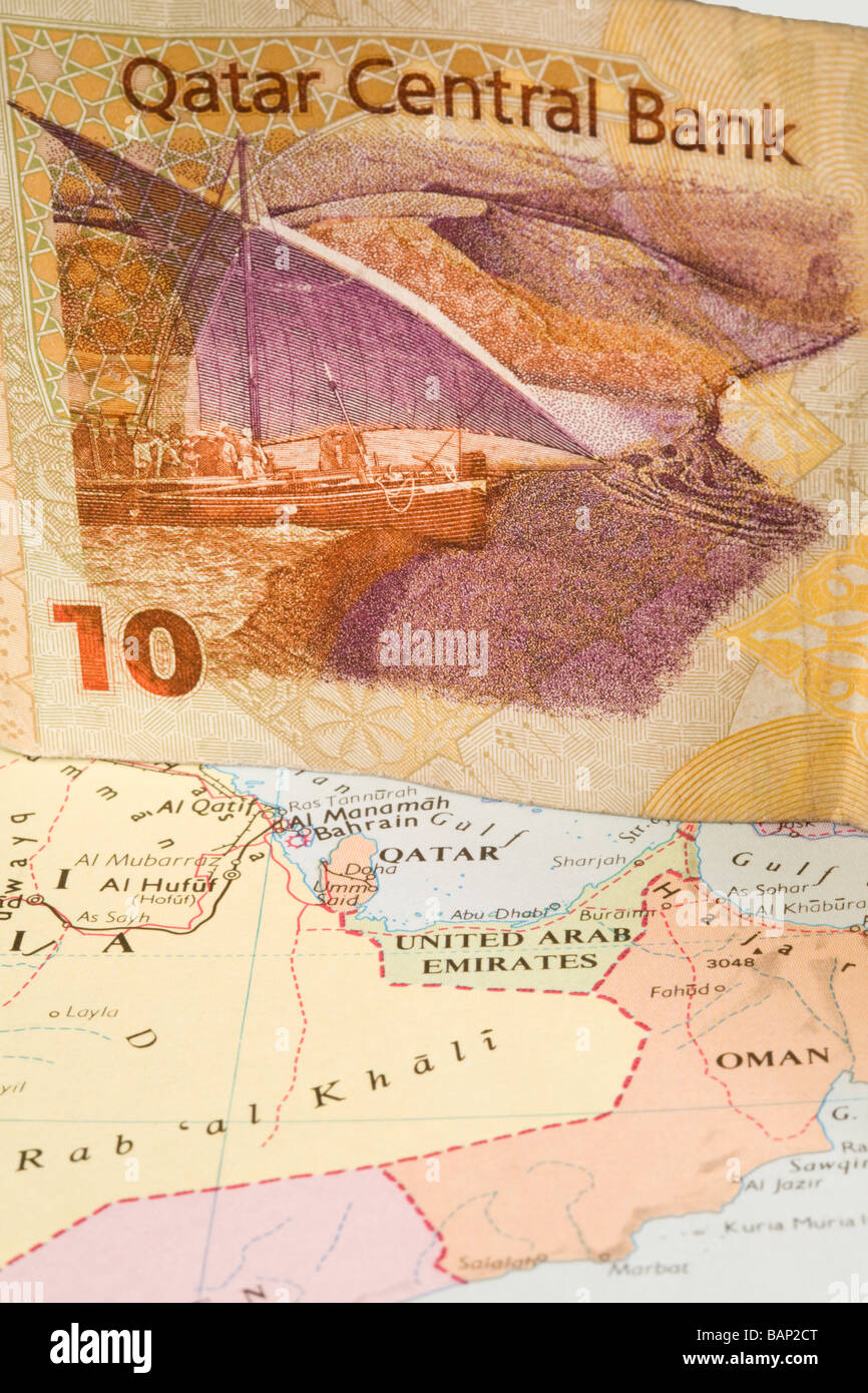Qatar Bank Note on a map of the area Stock Photo