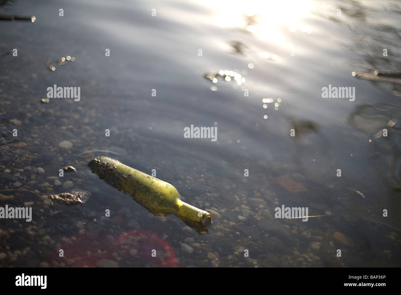 Green glass bottle floating in the East River, New York City, NY, USA 2009 Stock Photo