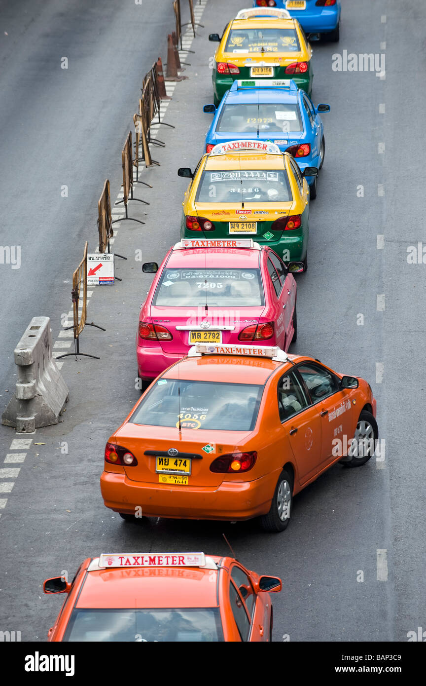 A line of Colourful Taxis waiting for fares near Chatuchak Weekend Market. Bangkok, Thailand. Stock Photo