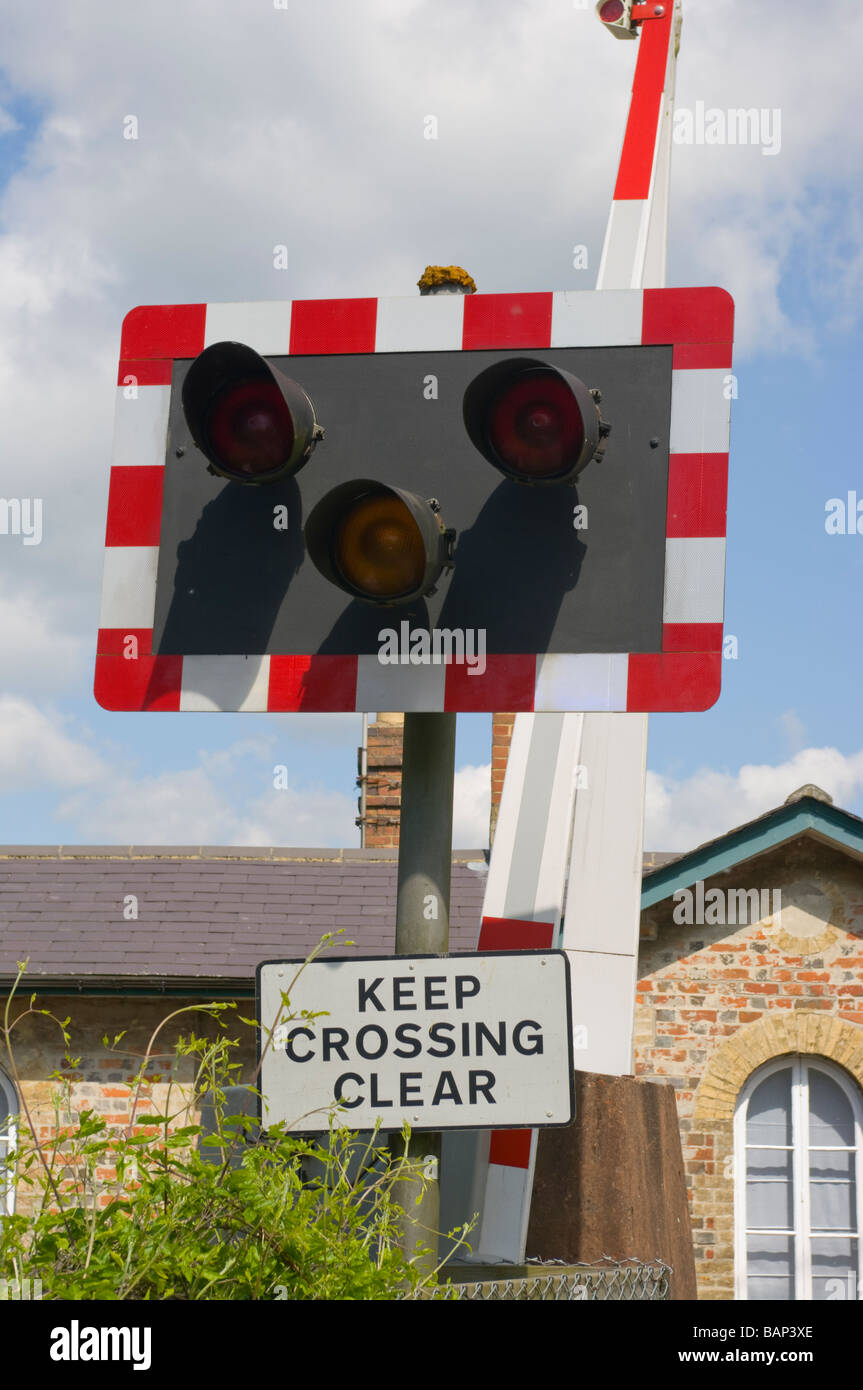 Railway Level Crossing Warning Lights and Keep Crossing Clear Road Sign Stock Photo