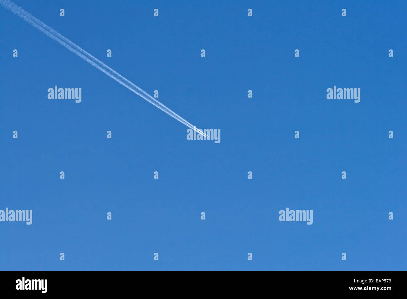 Pattern forming aeroplane contrails in the sky Stock Photo - Alamy