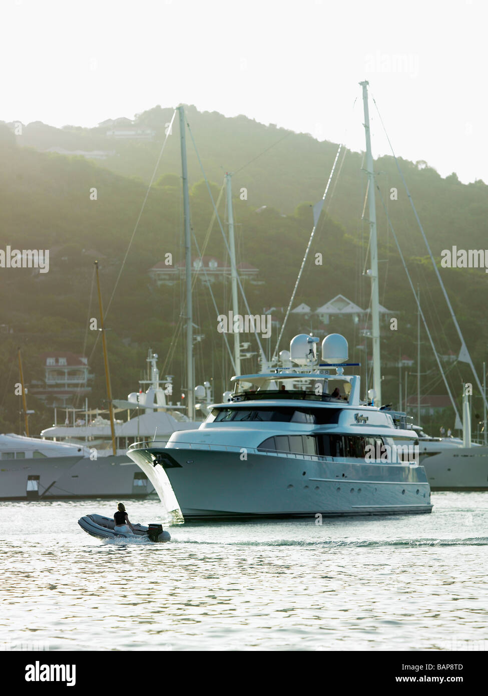 Super yacht manoeuvring in Gustavia harbor on St Barts Stock Photo