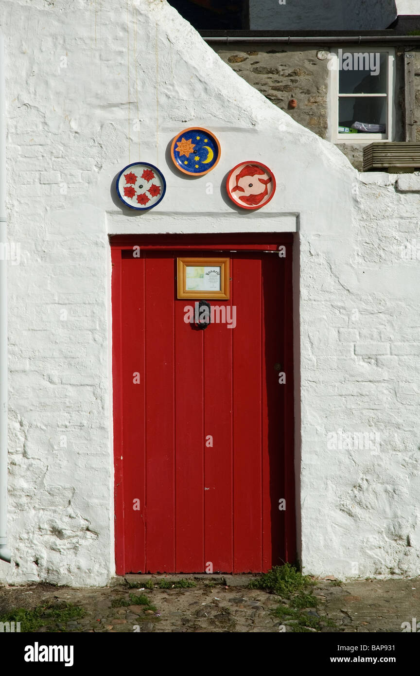 a red door in a white wall Stock Photo