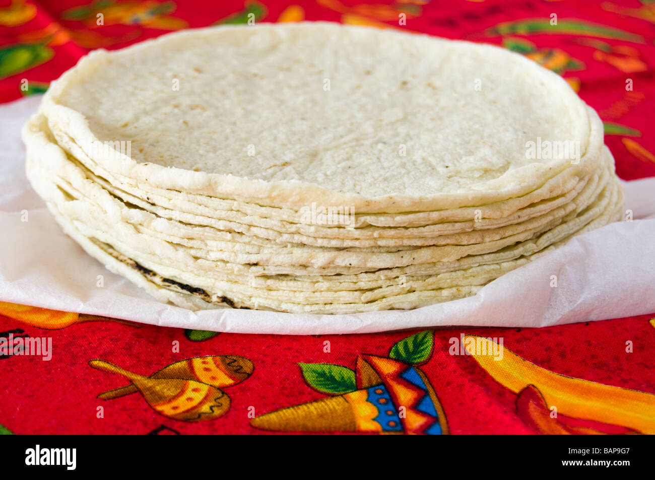 Stack of fresh corn tortillas on red tablecloth Stock Photo Alamy