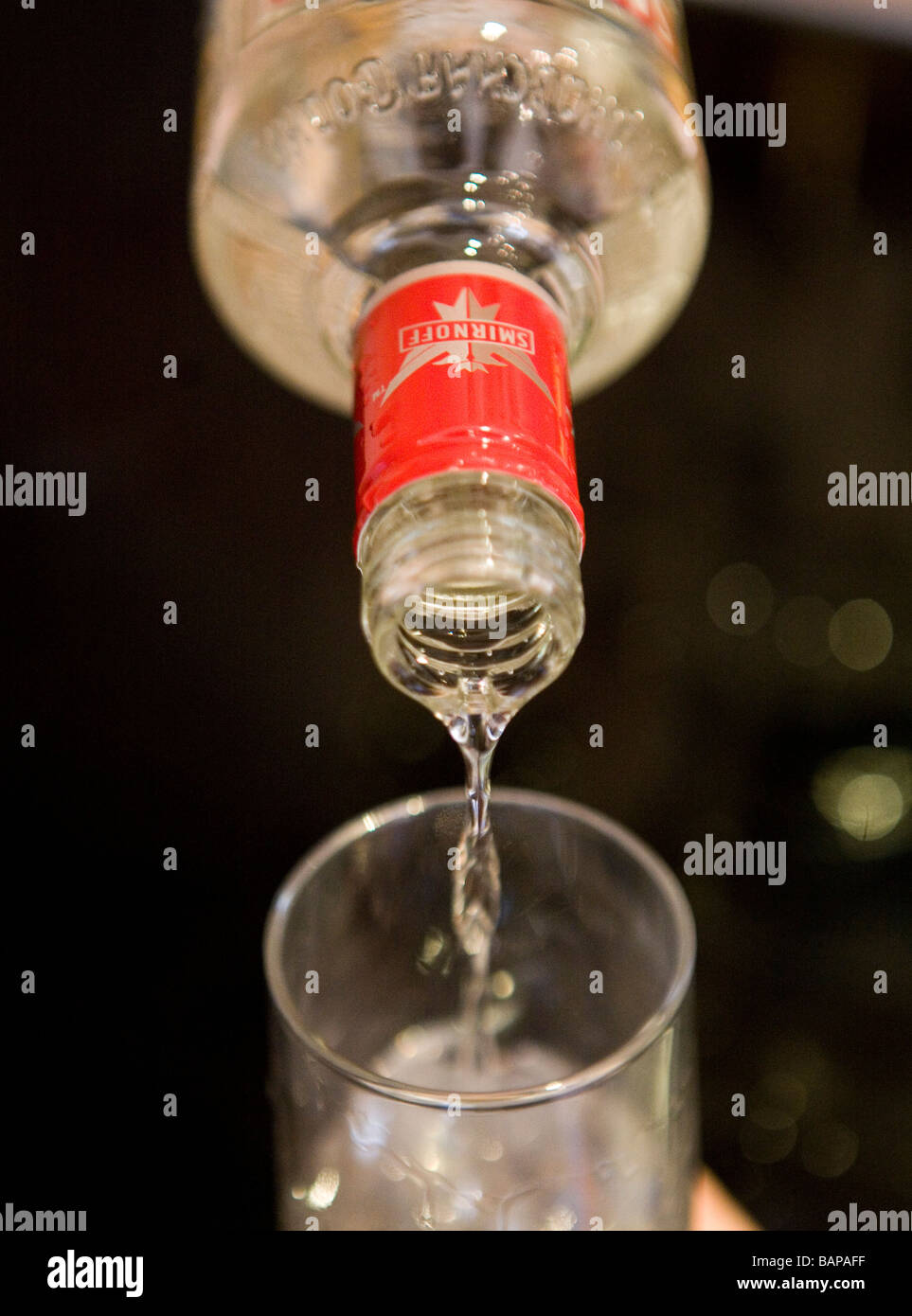 Smirnoff vodka is poured from a bottle on to a glass with ice Stock Photo -  Alamy