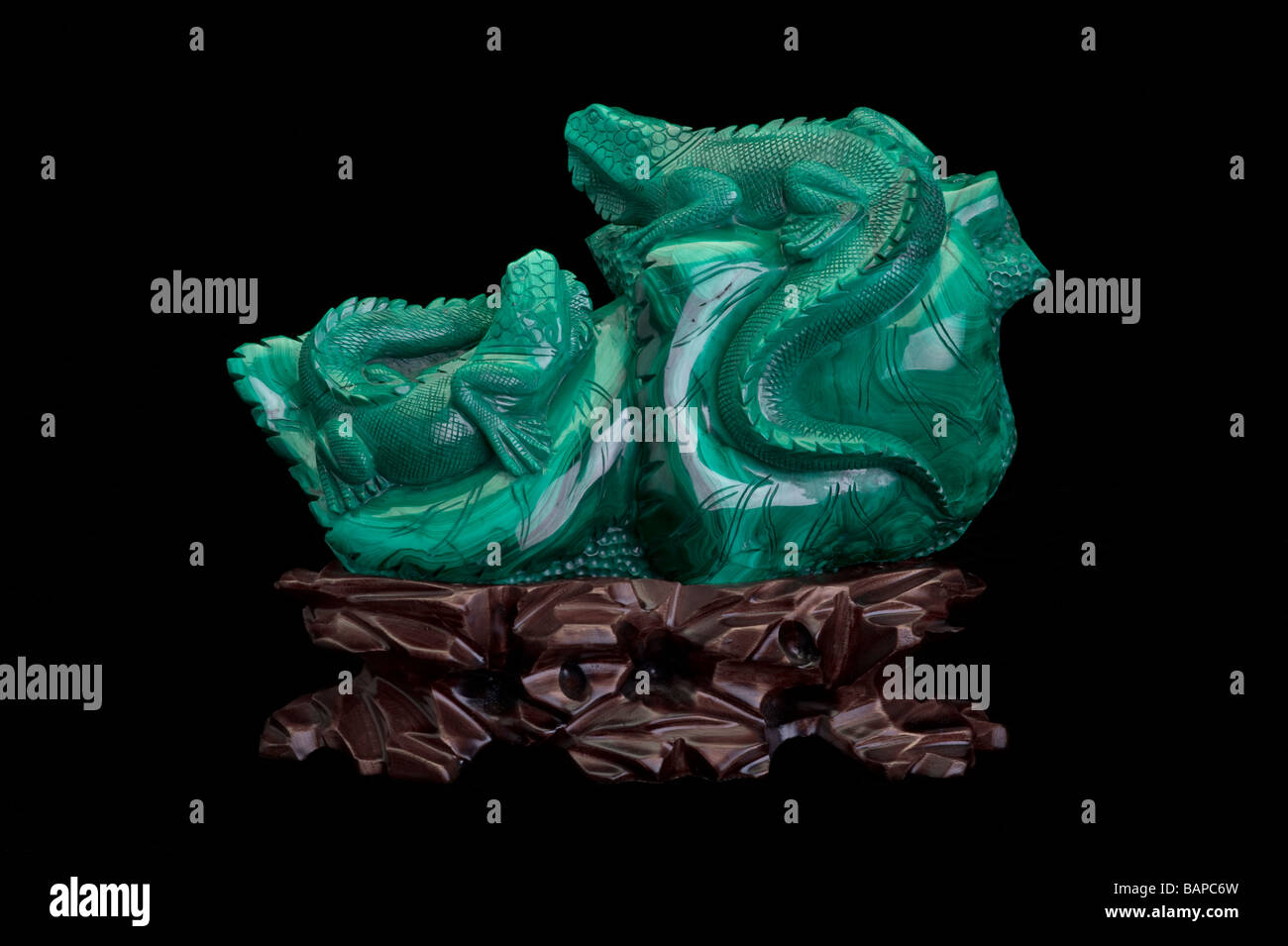 Malachite mineral carving on black background Stock Photo