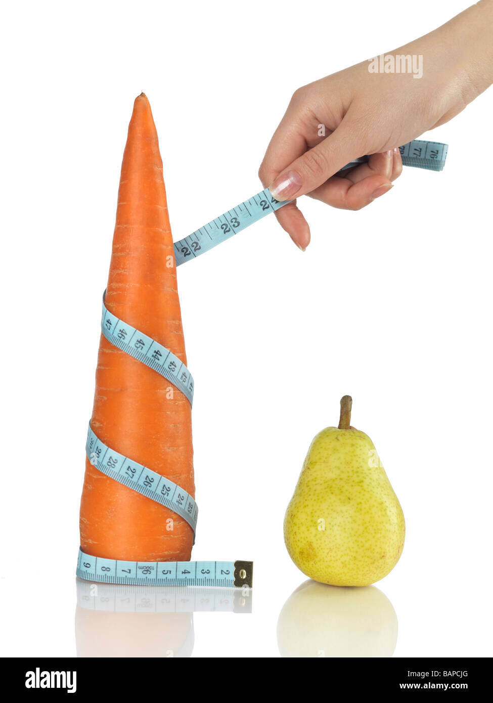 Woman with a tape measure around a carrot Stock Photo