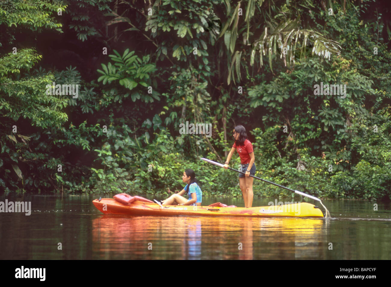 Girls paddling a kayak on river rainforest Costa Rica Stock Photo - Alamy