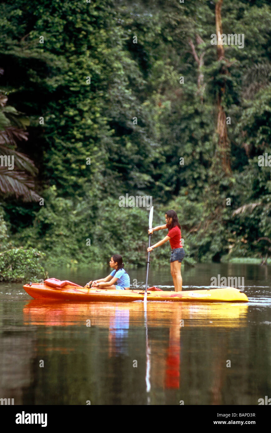 Girls paddling a kayak on river rainforest Costa Rica Stock Photo - Alamy