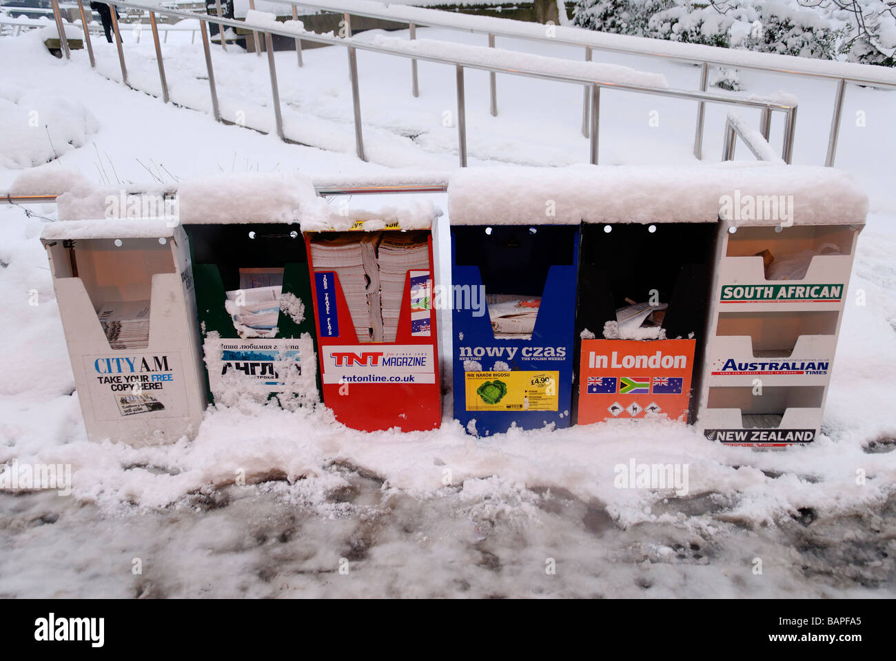 Snow Covered Free Newspaper Stand Tower Hill underground Station City London England Britain Stock Photo