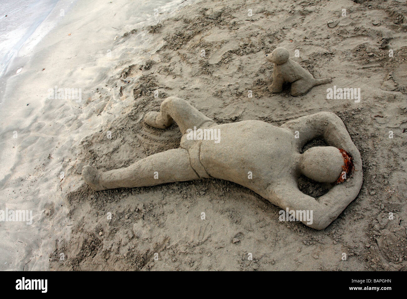 Humanoid male sand sculpture on beach in Runaway Bay, Jamaica Stock Photo