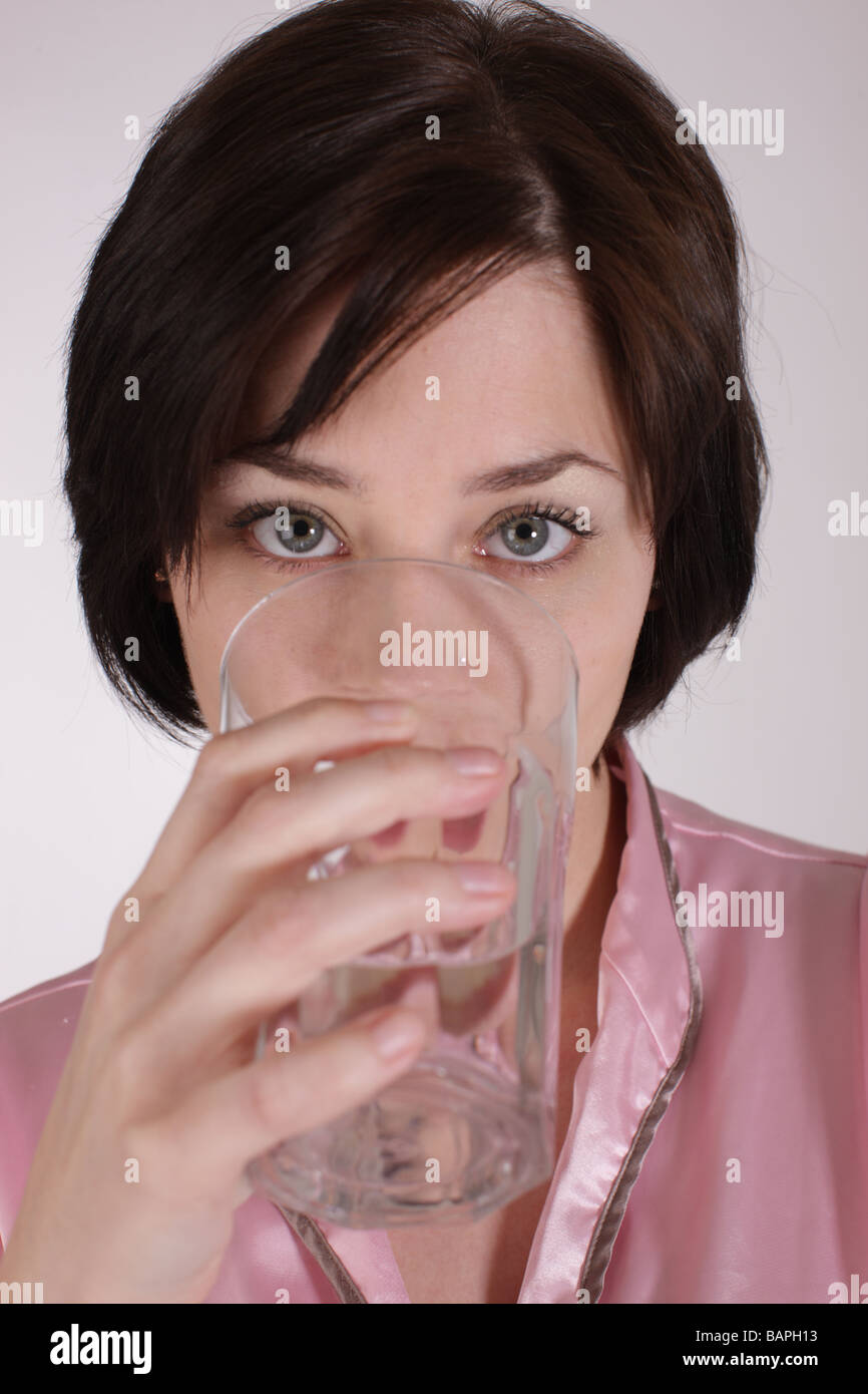 Girl or woman drinking water from a glass Stock Photo