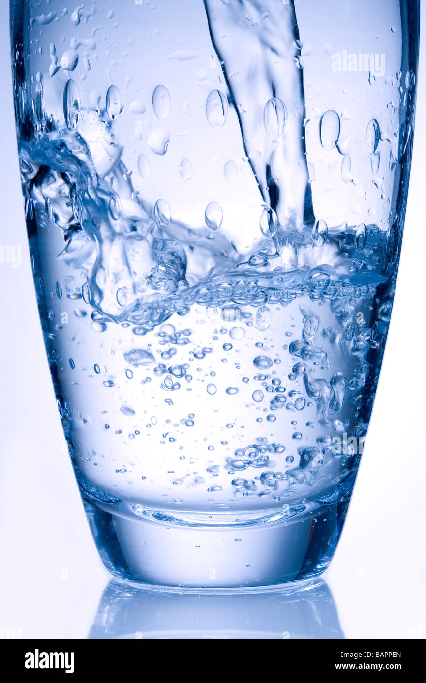 glass of mineral water pouring Stock Photo
