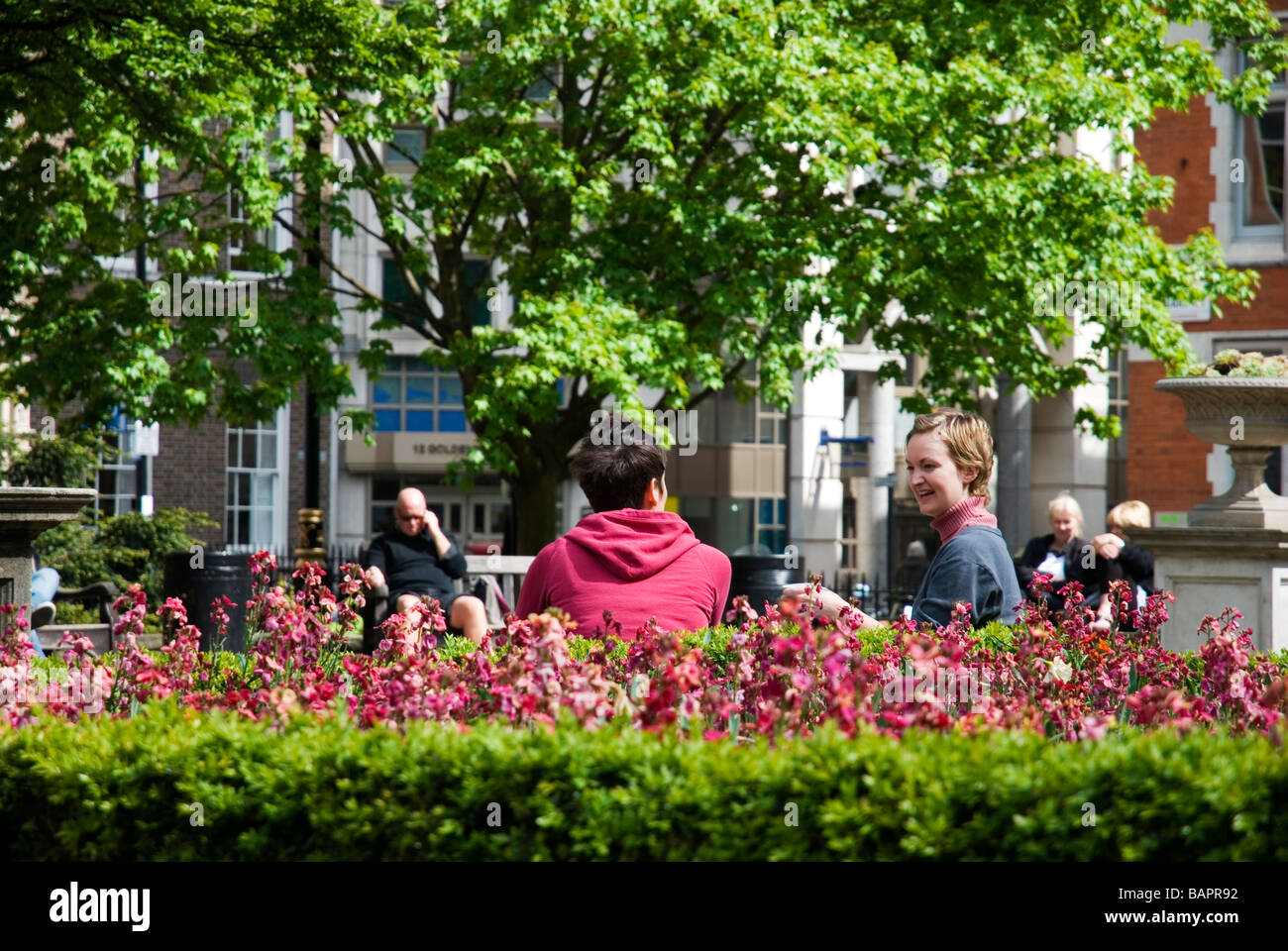 People at lunchtime in Golden Square Soho, London England UK Stock Photo