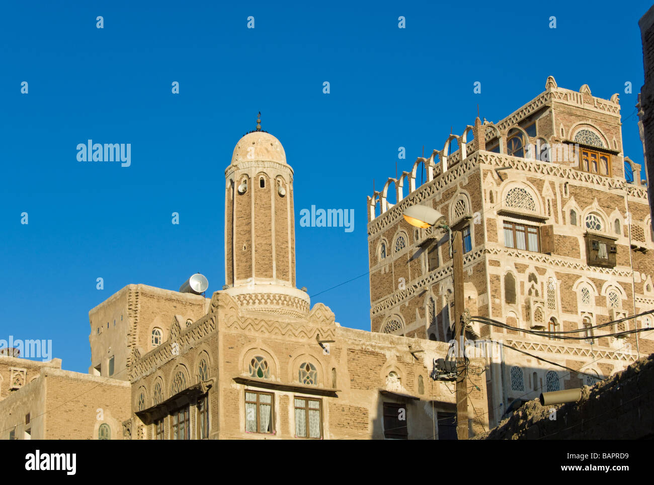 Traditional building with mosque in the old town district of Sana'a Yemen Stock Photo