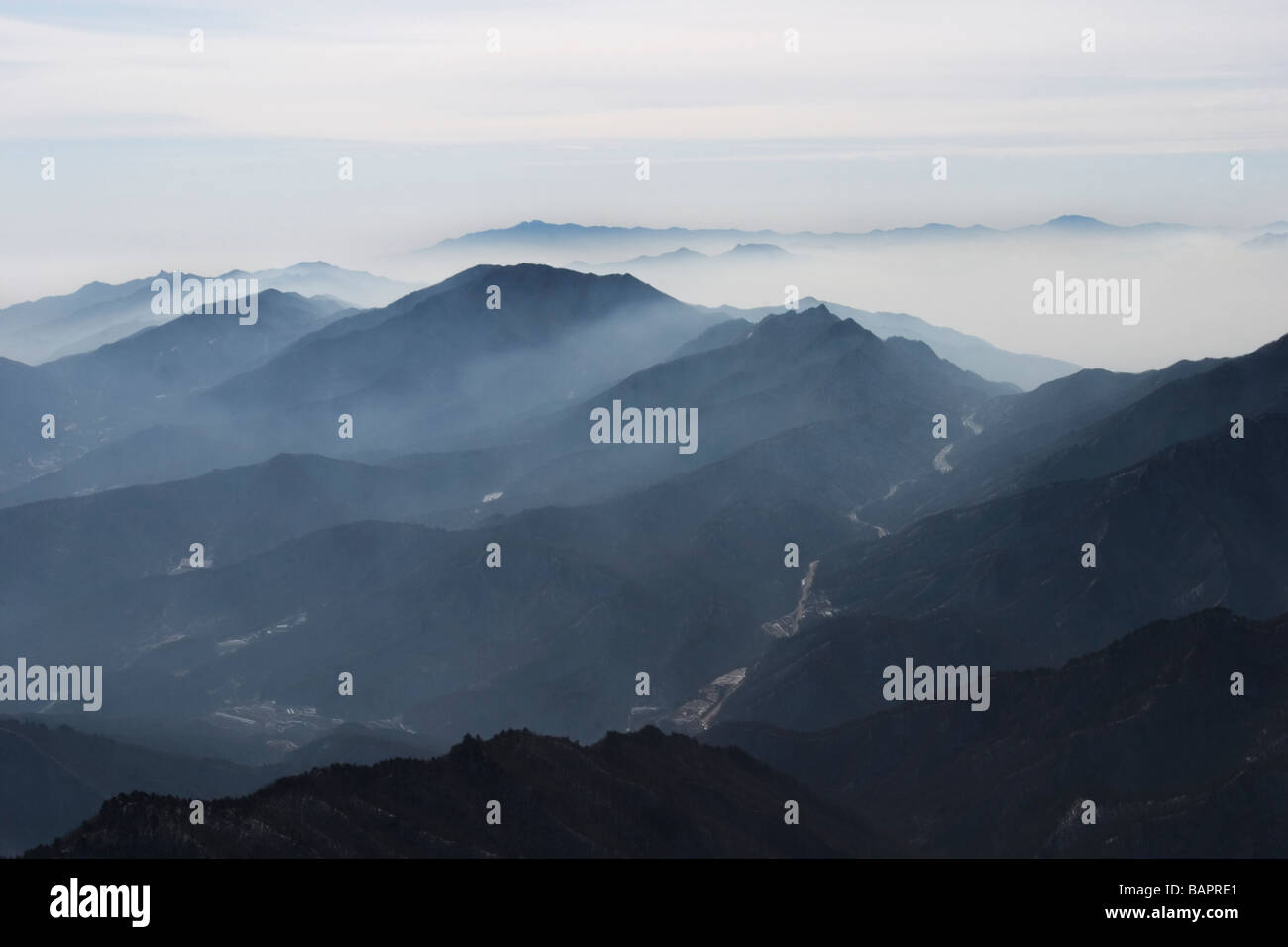 Mist hangs over the peaks of Deogyusan National Park near Geochang, South Gyeongsang Province, Republic of South Korea. Stock Photo