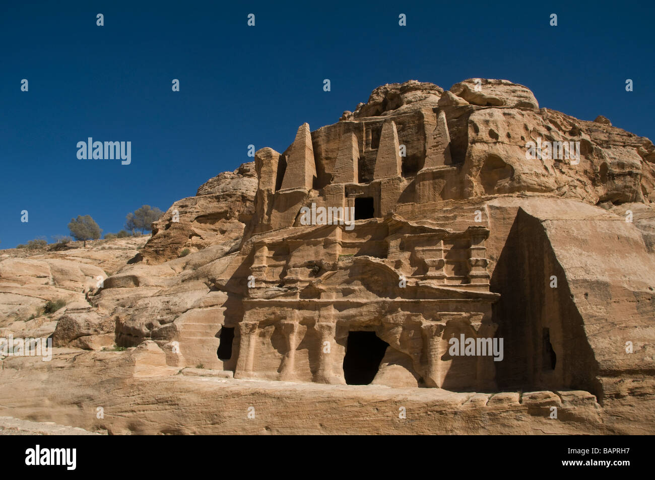 View of the rock cut monument 'Obelisk Tomb' carved into pink sandstone cliff in the ancient Nabatean city of Petra Jordan Stock Photo
