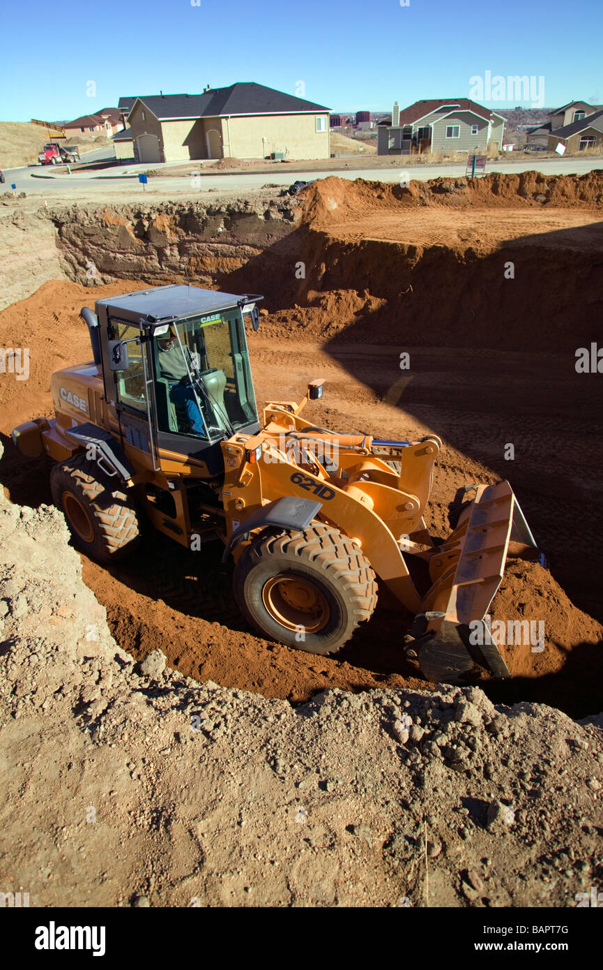 Front end loader excavating basements for new residential houses Stock ...