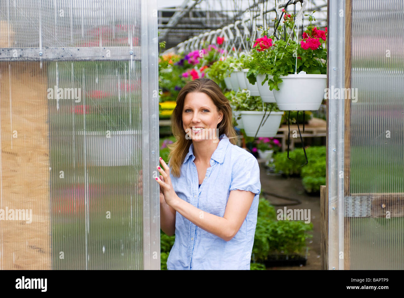 Woman in greenhouse Stock Photo - Alamy