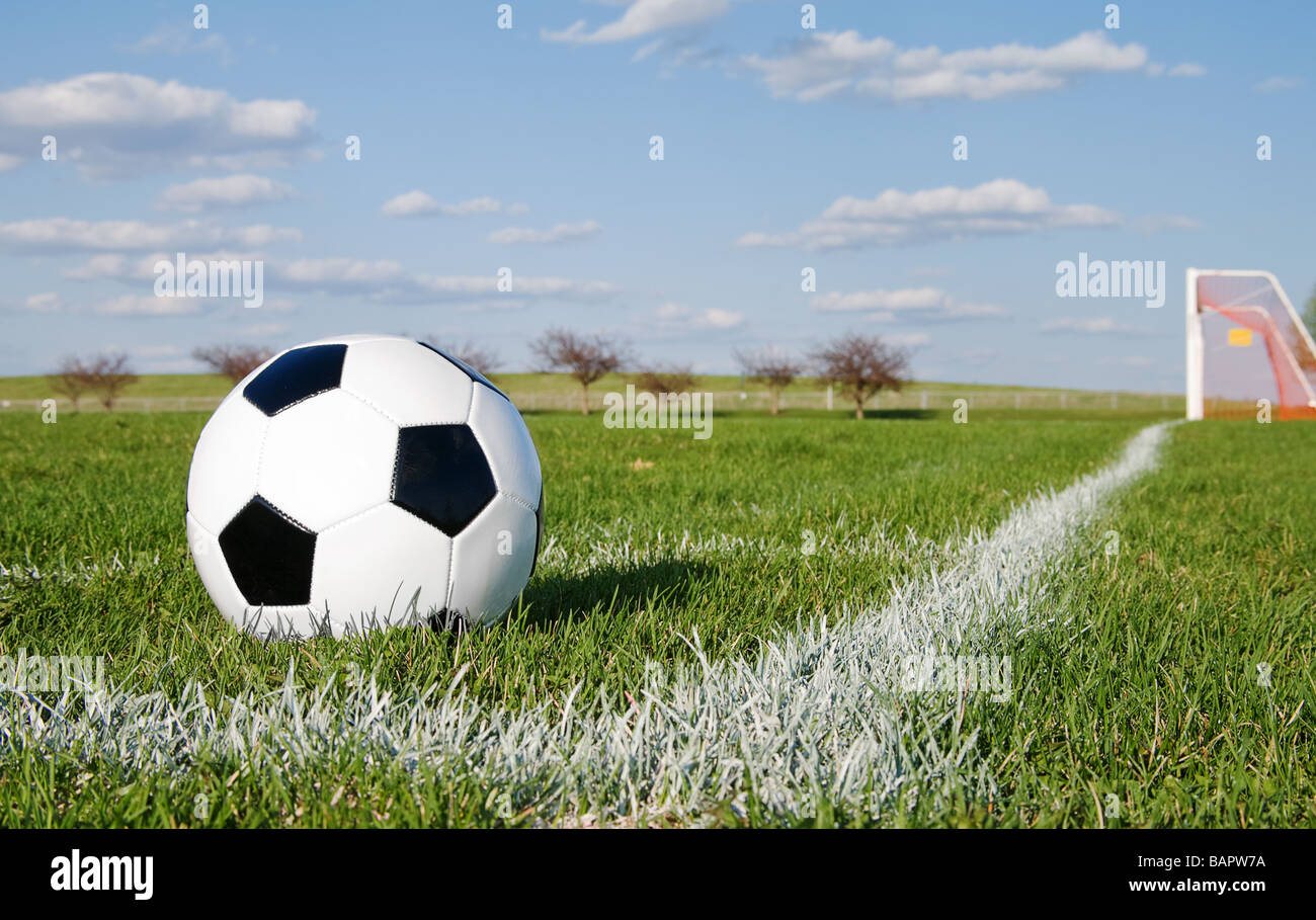 Soccer ball in corner pitch area against blue sky Stock Photo Alamy