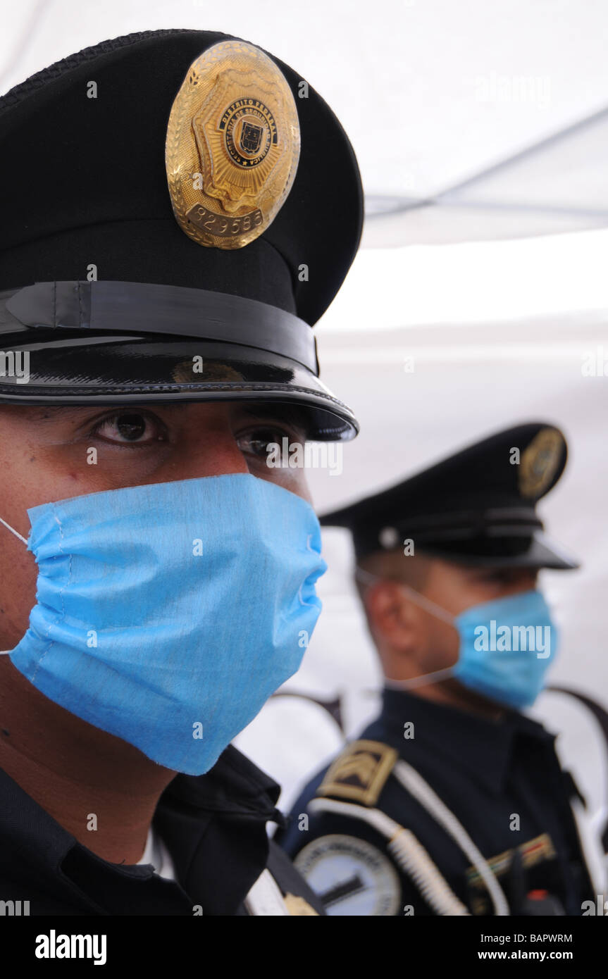 Police officers stand guard at a makeshift tent clinic in Mexico City, set up to detect cases of influenza Stock Photo