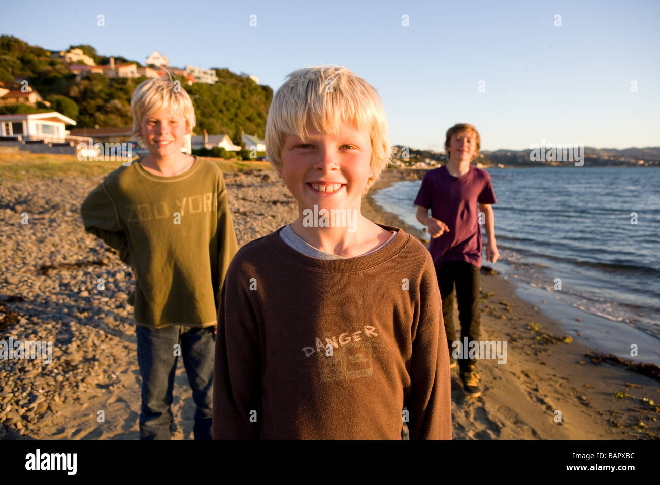 Boys on Plimmerton beach New Zealand Stock Photo Alamy