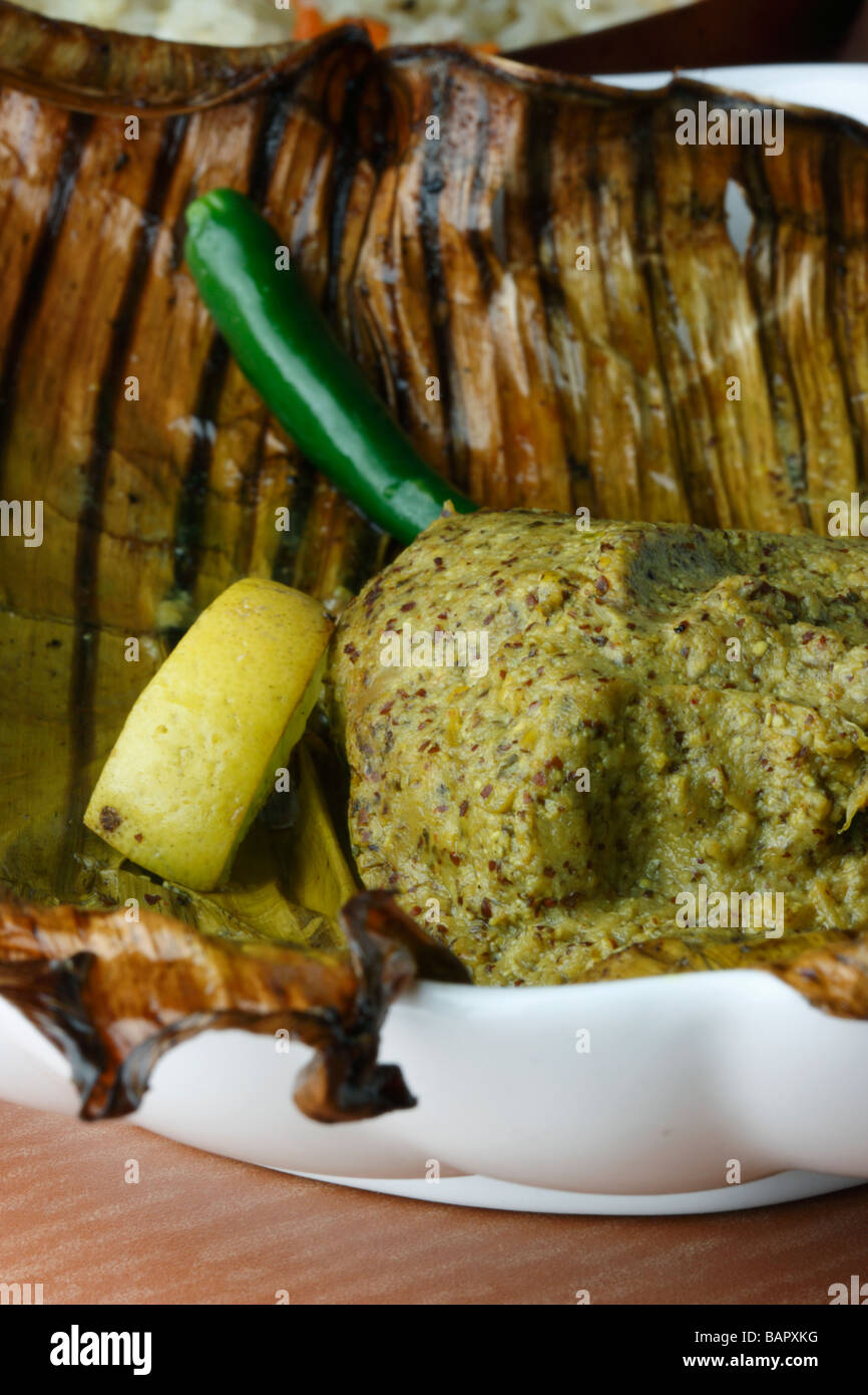 Bhetki paturi meaning fish seasoned with spices wrapped in banana leaves and then steamed or baked over a charcoal fire Stock Photo