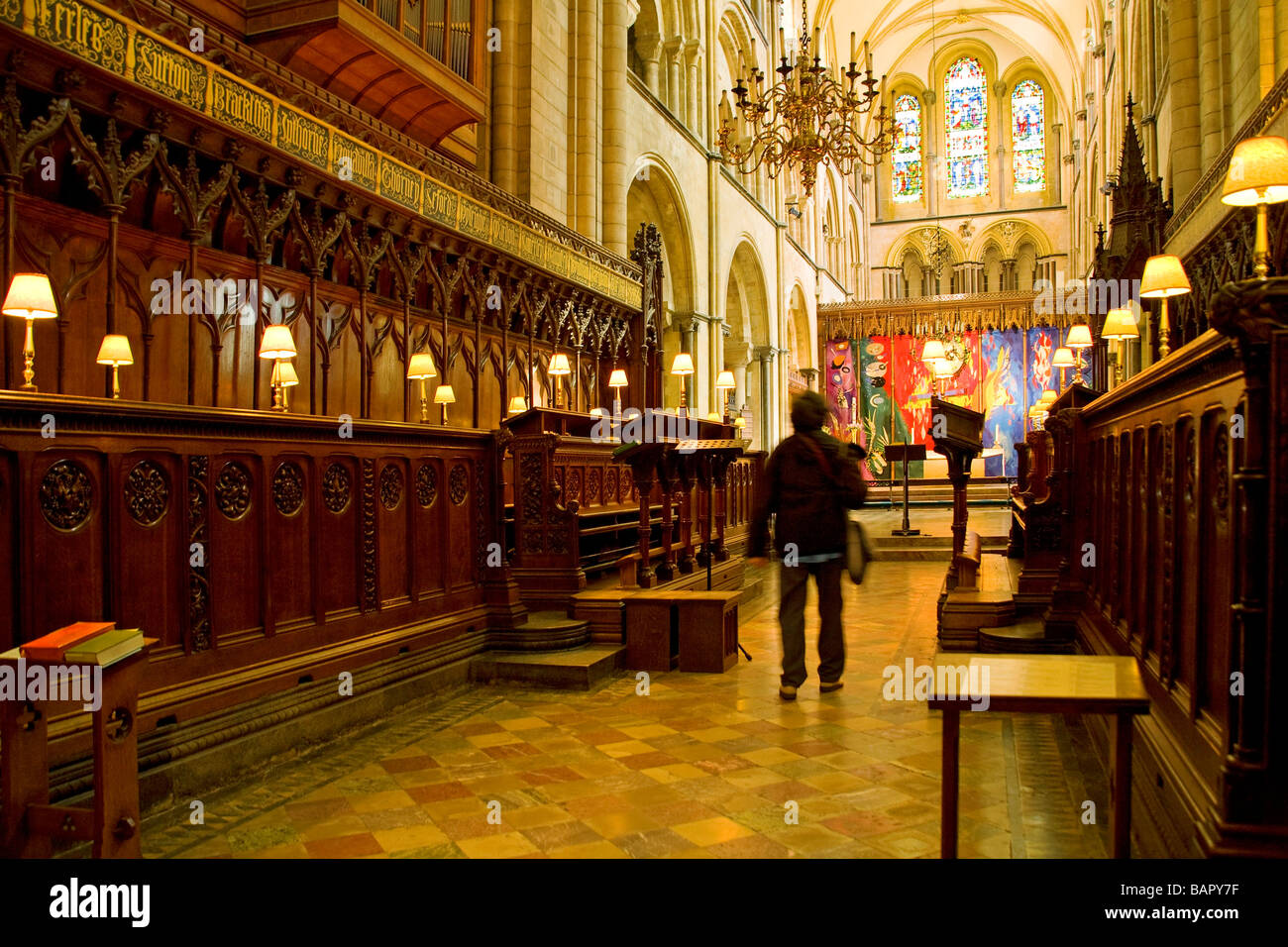 A visitor looking at the Choir stalls in Chichester Cathedral. UK Stock Photo