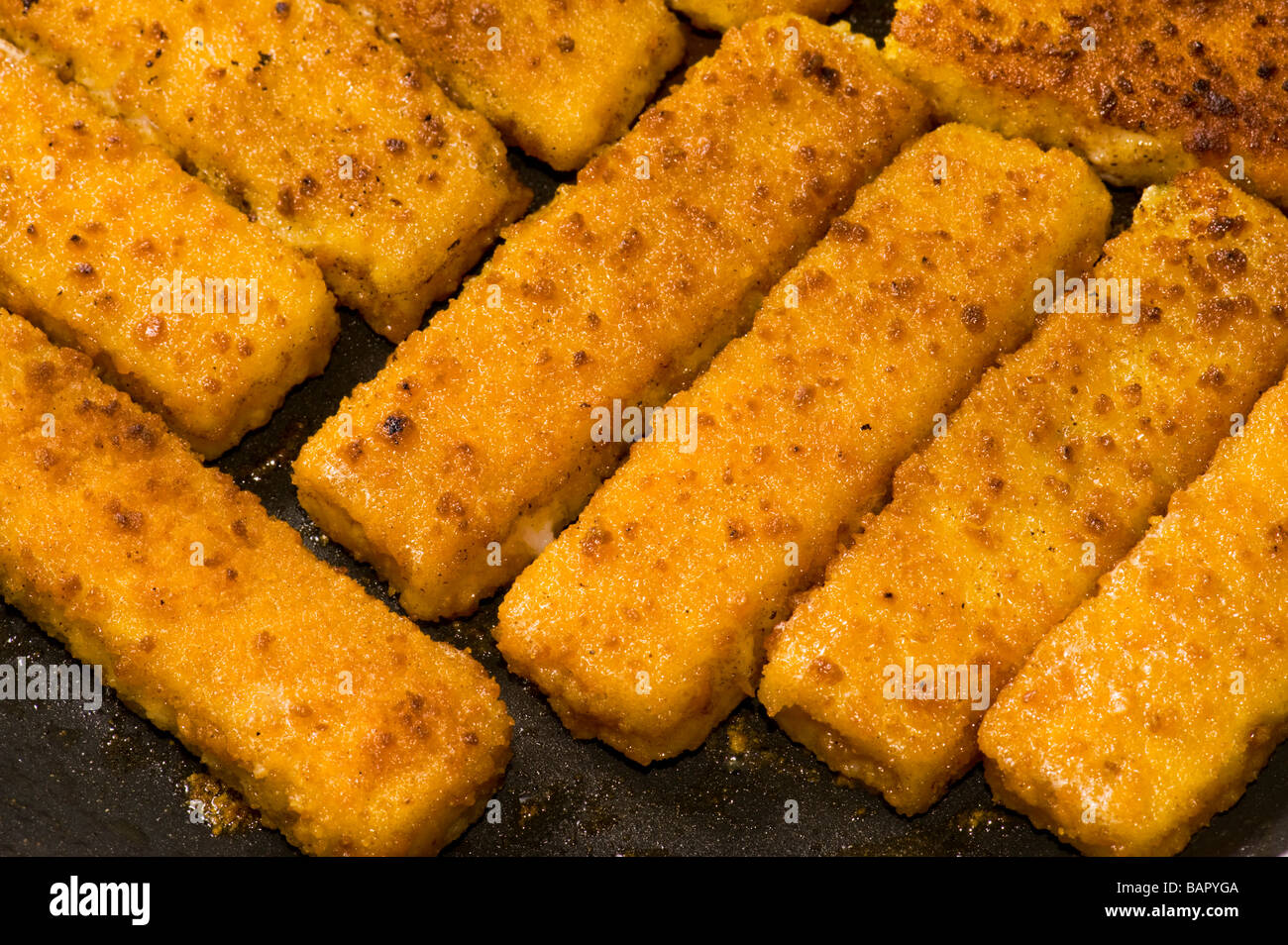 fried fish finger fish stick fry frying brown browning roast roasting roasted bake baking fat oil fryer fries seafood sea diet c Stock Photo