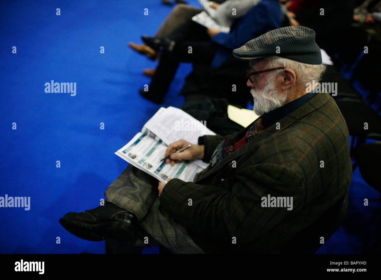A man looks through auction notes at the first US style auction of