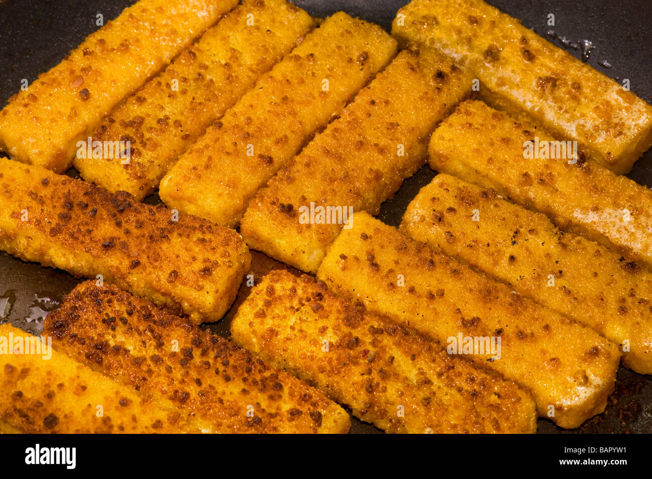 fried fish finger fish stick fry frying brown browning roast roasting roasted bake baking fat oil fryer fries seafood sea diet c Stock Photo
