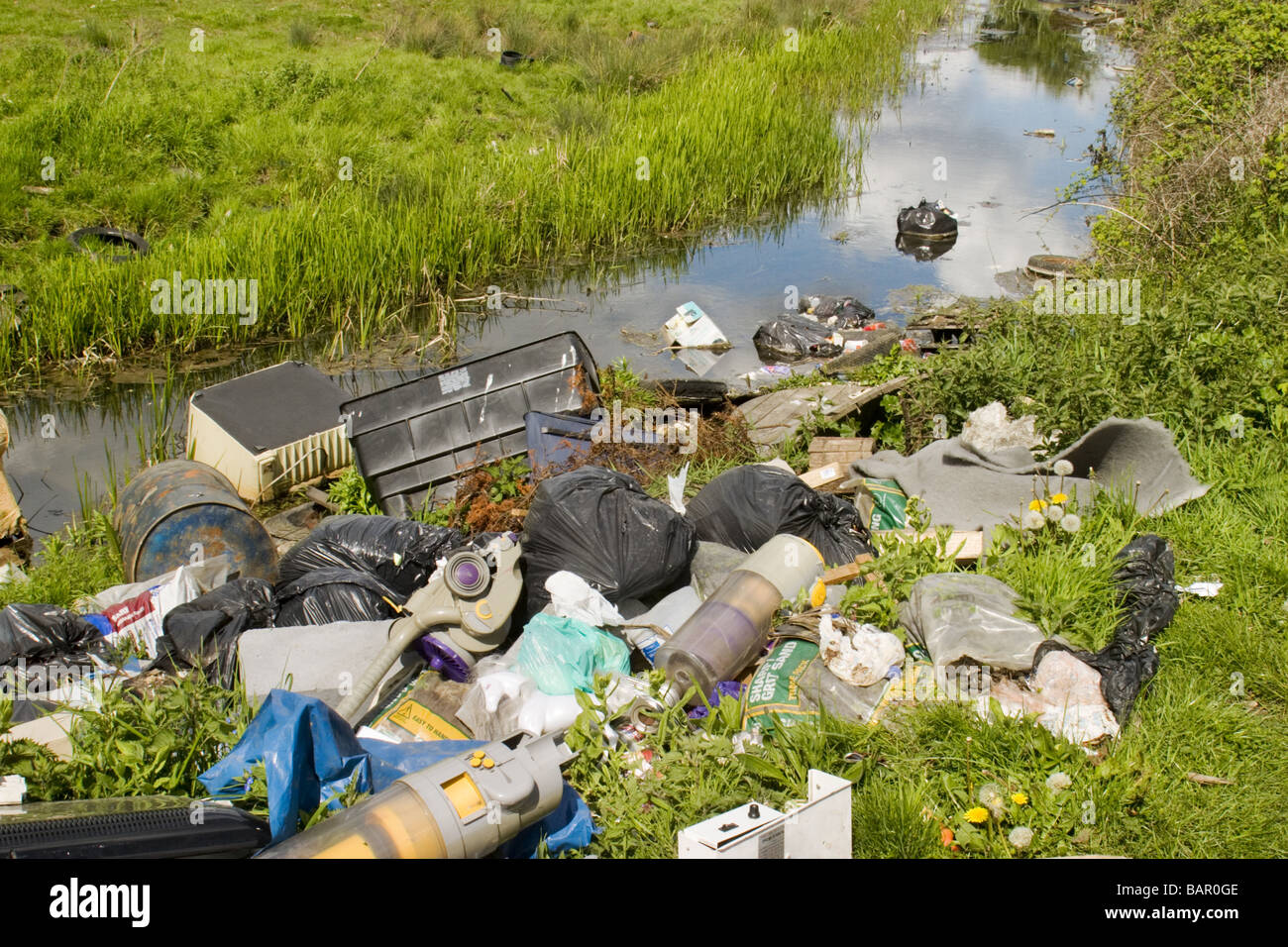 Rubbish fly-tipped into stream, Dartford, Kent ,UK Stock Photo