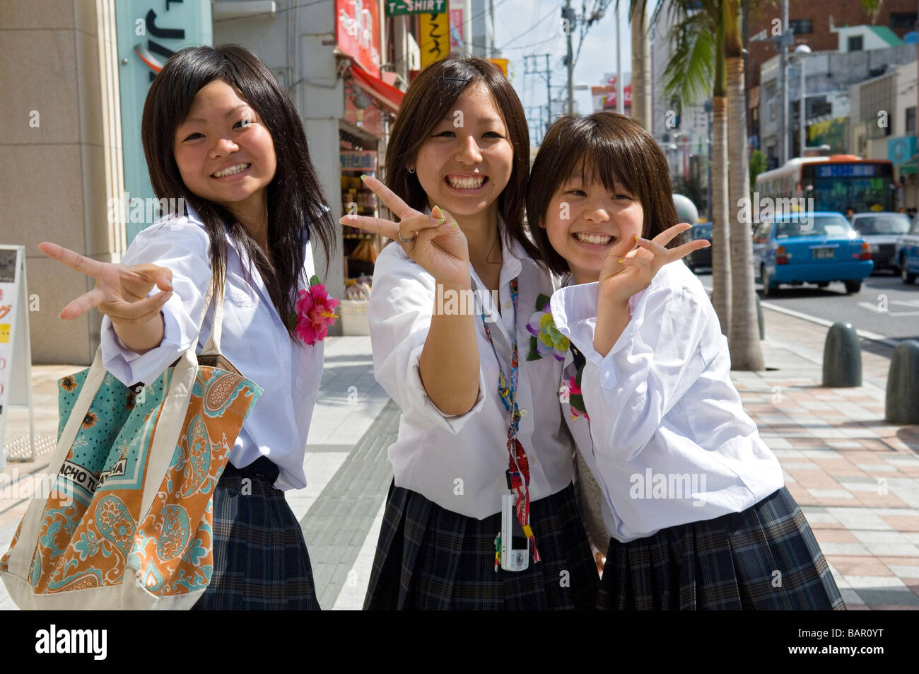 Japanese Schoolgirls shopping on Kokusai Dori Street in Naha, Okinawa, Japan Stock Photo